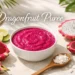 dragonfruit puree made from fresh pitaya fruit in bowl with sliced dragon fruit on table